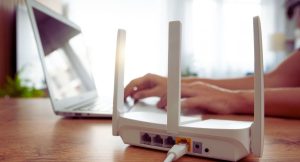 Routeur Wi-Fi moderne pose sur une table claire dans une piece lumineuse